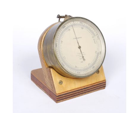 A T Wheeler brass compensated aneroid barometer  London, dated 1940, with purpose made stand, 12cm diameter