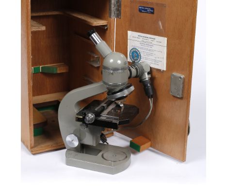 An Olympus monocular electric illuminated microscope with wooden case