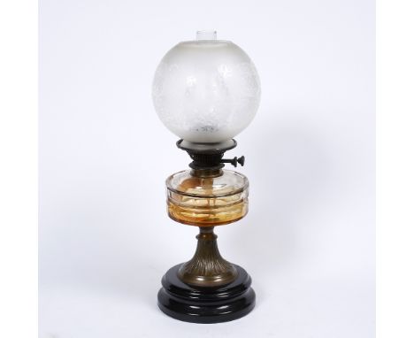 A Victorian glass oil lamp with shade