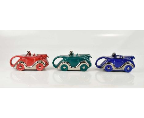 SADLER; three racing car teapots, each in unusual colourways with silver highlights (3).Condition Report: Green; with crazing