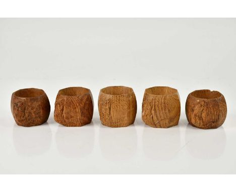 WORKSHOP OF ROBERT MOUSEMAN THOMPSON; five adzed oak octagonal napkin rings, height 4cm. (5). Condition Report: Light wear to