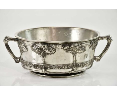 DAVID VEASEY FOR LIBERTY &amp; CO; an Arts &amp; Crafts Tudric pewter twin handled footed bowl, relief decorated with trees a