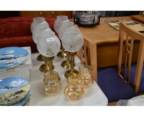 A set of six brass light fittings with frosted glass shades and three other glass shades