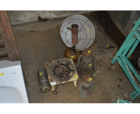 A vintage stove; together with two hurricane lamps etc