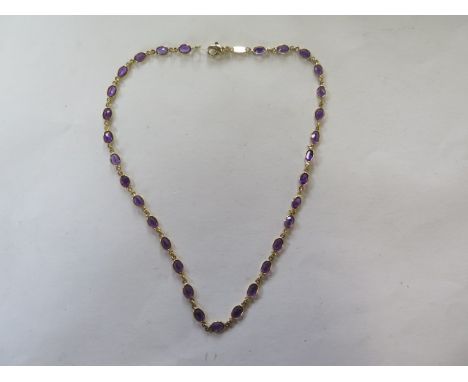 An 18ct yellow gold amethyst necklace, 40cm long, approx 11.2 grams, in good condition, marked 750 