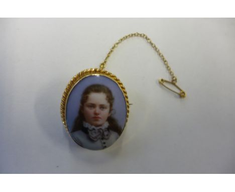 A fine quality 9ct gold brooch with a Berlin style hand painted on porcelain portrait of a young woman, unsigned, measures 3c