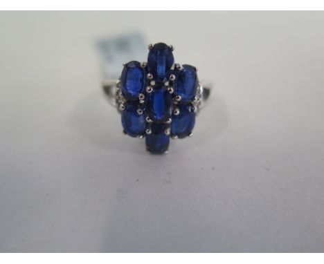 A 9ct white gold and Himalayn kyanite and diamond cluster ring, total 5.46 carats of stones, size N 1/2 - approx weight 4.66 