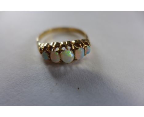 An 18ct gold five stone opal ring, size O/P, approx 2.9 grams, some wear but generally good 