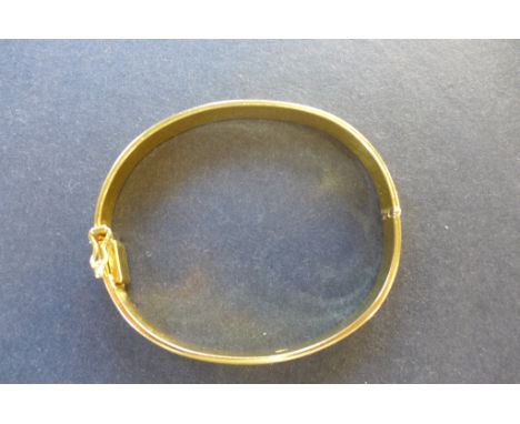 A heavy 18ct yellow gold hinged bangle, stamped 750 - diameter 53mm, internal circumference approx 17cm, weight approx 32 gra