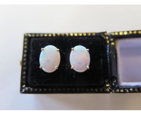 A pair of 14ct yellow gold oval opal earrings, approx 8mm x 6mm - in good condition 