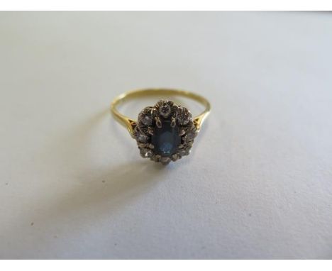 An 18ct yellow gold diamond and sapphire ring, the central sapphire approx 7.5mm x 4.8mm x 3.2mm, ring size R, approx 3.3 gra