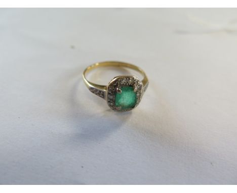 An 18ct yellow gold emerald and diamond ring, the emerald approx 6mm x 5mm x 2.5mm - ring size N, approx 2.7 grams, chip to e