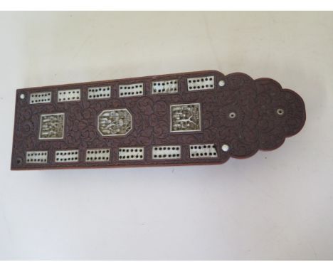 A Chinese bone inlaid carved wooden cribbage board with pins, 25cm long, reasonably good, some losses 