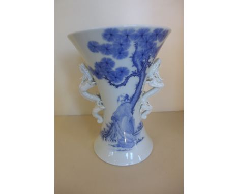 A modern trumpet shaped blue and white oriental vase with dragon handles, minor damage to dragons, otherwise good, 25cm tall,