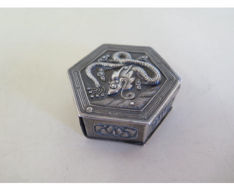 A Chinese 19th/20th century silver hexagonal box, decorated with a dragon and panels of plants, seal mark to inner base, 5cm 