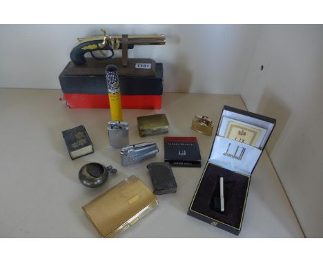 A collection of smoking related items, including a Derringer pistol lighter 