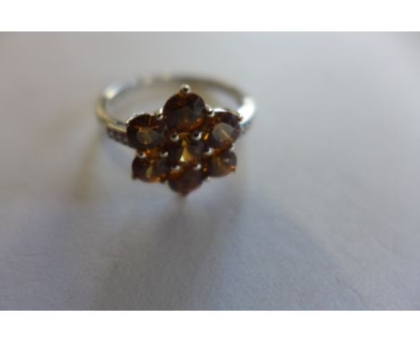 A 9ct white gold cinnamon zircon and diamond floral cluster ring, size N/O, approx 2.7 grams 