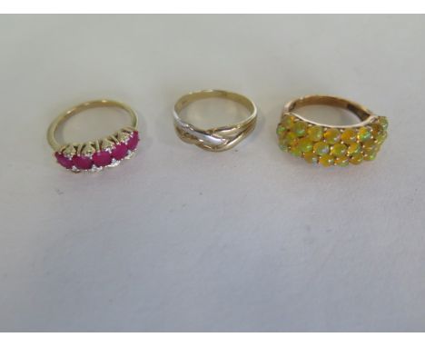 A 9ct gold and yellow opal ring, set with 0.25 opals - A 9ct gold ruby and diamond ring and a 9ct gold plated ring, total wei