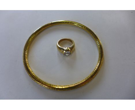 A silver gilt ring, size K, some wear to edge, and a gilt plated bangle 