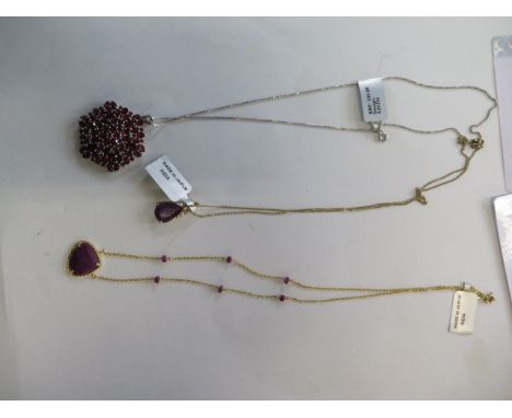 Two gold plate on silver ruby pendants, one set with diamonds, and a large garnet pendant - as new, some certificates 