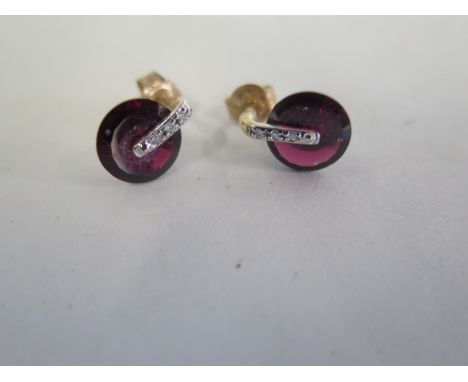 A pair of 9ct gold torus ring garnet and diamond earrings, stone diameter 8mm, total height 10mm, approx weight 2.2 grams 