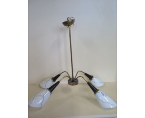 A retro 1960's ceiling pendant lamp in the Sputnik style, each of the four white glass shades decorated in an abstract style 