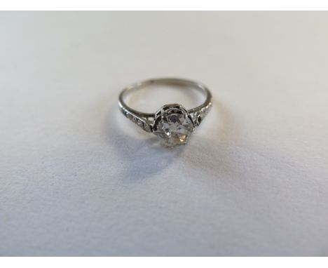 A diamond solitaire ring, the central diamond approx 0.70ct, with three small diamonds to each shoulder, ring size I, approx 