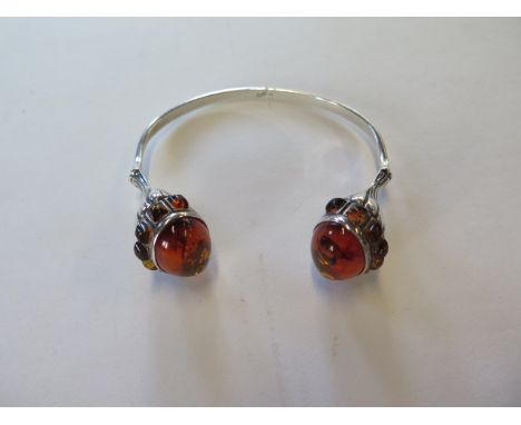 A silver designer amber bangle, 7.5cm wide 