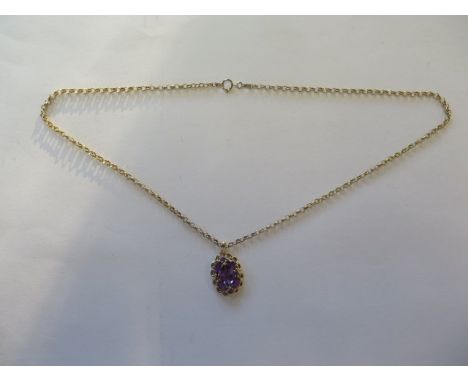 A 14ct yellow gold amethyst pendant on a modern 9ct chain, total weight approx 6 grams, pendant 2cm x 1.5cm - in good conditi