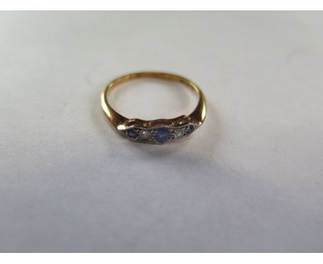 An 18ct yellow gold ceylon sapphire and diamond ring, set with three sapphires, inter-spaced with two small diamonds, size R 