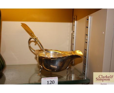A silver cream jug and a silver fiddle pattern ladle