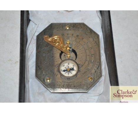 A small vintage replica sundial and compass