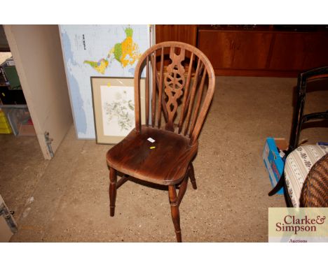 A pair of stick and wheel back dining chairs