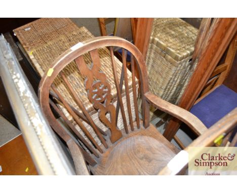 An elm seated stick and wheel back elbow chair