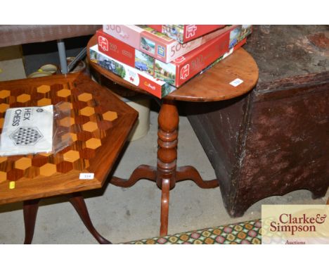 An antique tilt top tripod occasional table