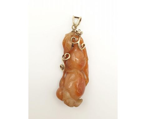 A large carved Chinese Red jade pendant set in 14k yellow gold, 25.4g weight and 7.5cm drop approx 