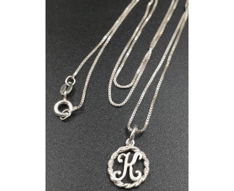 Sterling silver chain and floral initial K pendant. 