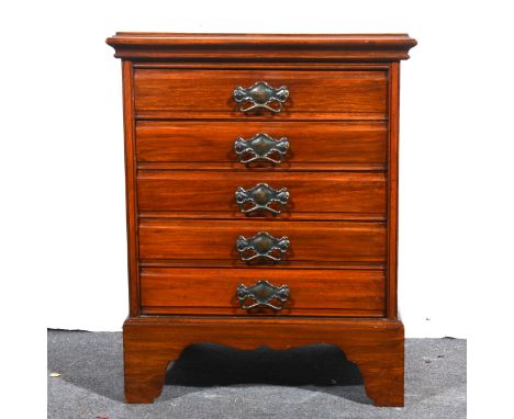 An Edwardian walnut music cabinet, rectangular top with a moulded edge, five drawers with fall fronts, bracket feet, width 51