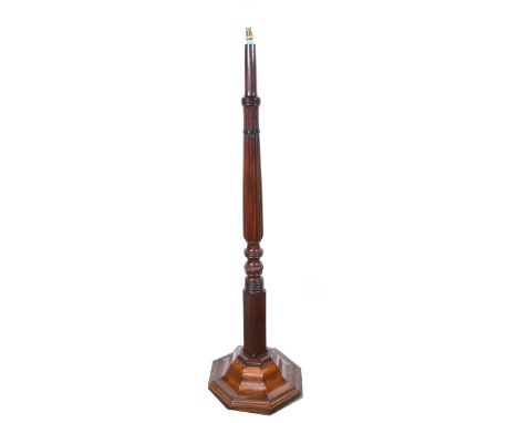 A mahogany standard lamp, adapted from a bedpost, stepped octagonal base, height excluding fitments 165cm.