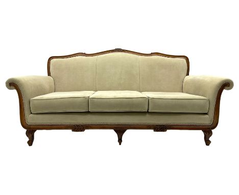 French design stained beech framed three-seat sofa, moulded frame carved with flowers and foliage, upholstered in pale neutra