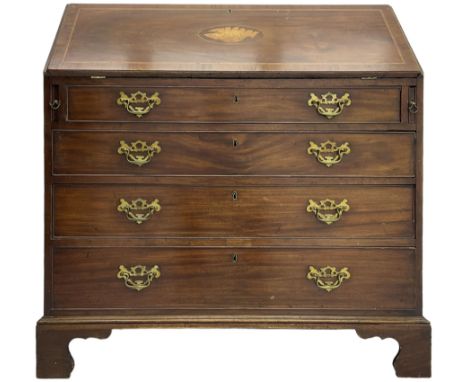 George III mahogany bureau, the conch inlaid fall front enclosing pigeon holes, shelves and central cupboard with inlaid flow