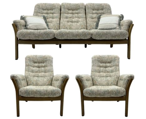 Ercol - mid-century three-piece ash lounge suite, featuring a three-seater sofa upholstered in a floral and woodland bird pat