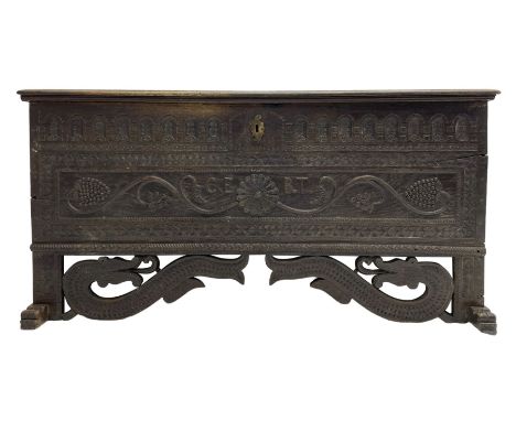 George III oak blanket box or kist, moulded rectangular top over hinged fall-front, with arcade frieze and central flower hea