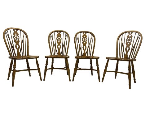Set of four elm Windsor dining chairs, hoop and stick back with shaped wheel splat, dished seat on turned supports united by 