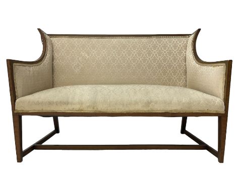 Edwardian mahogany framed two-seat sofa, curved wingback frame with satinwood banding, upholstered in beige fabric, on square