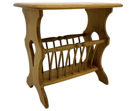 Ercol - light elm magazine rack side table, raised on pierced supports with rounded rectangular table top over turned spindle