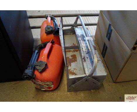 A metal toolbox and two petrol cans