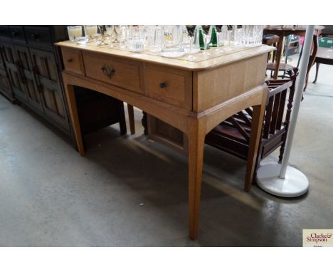 A light oak desk fitted three drawers