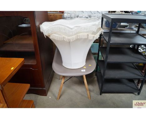 A plastic chair and two lamp shades