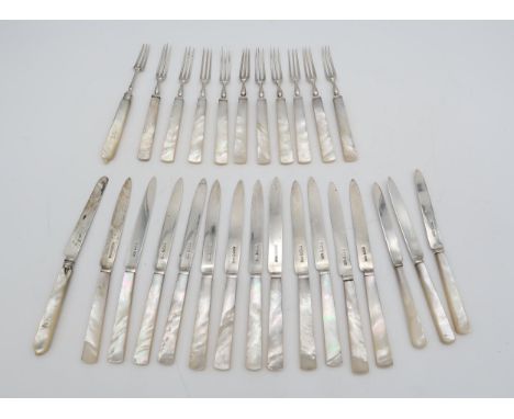 A set of George V silver mother of pearl fruit knives and forks, Sheffield 1924, ten forks and twelve knives, three more kniv